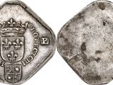an old silver coin with a crown on top of it