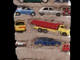 many toy cars that are on display on the wall