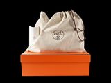 an orange box with a white bag sitting on top of it