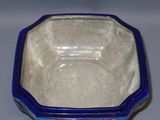 a blue and white bowl on a white table