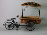 a small wooden cart with a bicycle attached to it