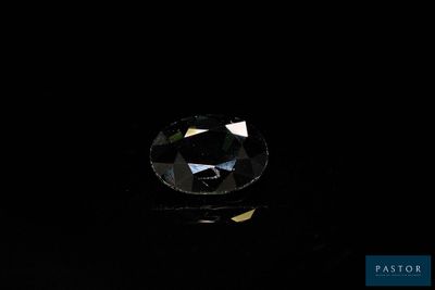 a close up of a black diamond on a black surface