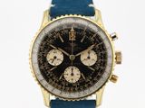 une photo d'une montre dorée et noire avec un bracelet bleu