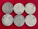 six pièces d'argent britanniques différentes sur fond rouge