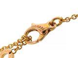 a close up of a gold chain with a key on it