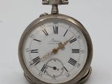 a silver pocket watch with roman numerals on it