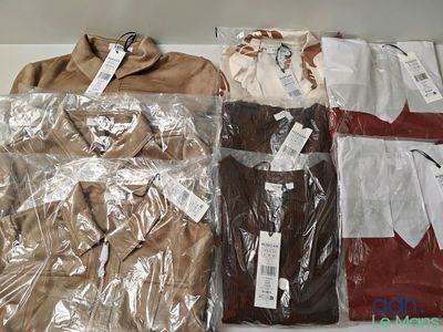 a lot of men ' s shirts on display in a store