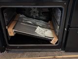 a black oven with a pan in it that has a heater inside of it