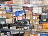 a metal cage filled with lots of boxes of assorted items