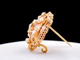 a gold ring with an umbrella on top of a white plate