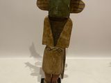 an image of a wooden sculpture of a man with a hat on his head