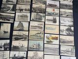 a lot of old photos of ships on the table
