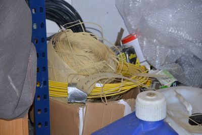 a pile of wires and other items in a room