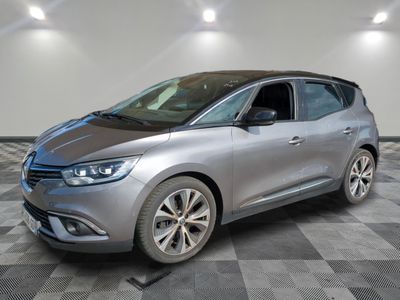 a silver car parked in a room with a checkered floor