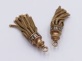 pair of gold tone tassels with black and white beads
