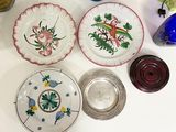 many plates and vases sitting on a table