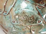 a close up of a green vase with a man on it