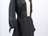 a black and white dress with a white collared neckline on a mannequin stand