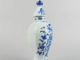 blue and white vase with a lid and a bird on the top