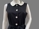 a black and white dress with a collared neckline