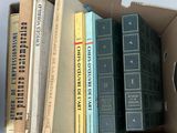 many books in a cardboard box on the table