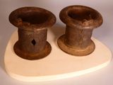 two brown vases sitting on top of a wooden stand