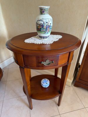 a small table with a vase on top of it