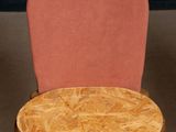 a wooden table with a pink chair on top of it