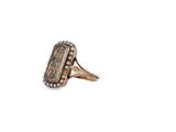 a close up of a gold ring with a stone in it