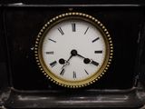 a black and gold clock with roman numerals on it
