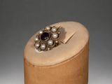 wooden box with a ring on top of it on a gray surface