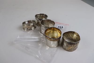 five silver cups sitting on a table with a price tag