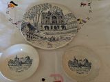 three plates on the table with a picture of a house on them
