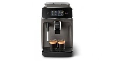 une machine à café devant laquelle se trouvent deux tasses de café