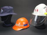 three different types of hard hats and helmets on a black background