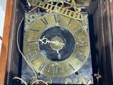 a clock that is sitting on a shelf in a room