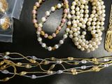 many different types of jewelry on display on a table