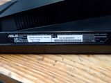 a close up of a black laptop on a wooden table