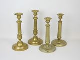 three brass candlesticks on a white background with a white background