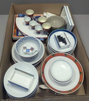 a box with a variety of plates and bowls in it