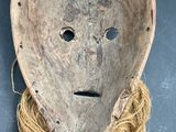 an old mask with a long hair on a table