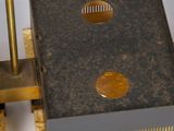 a metal object that is sitting on top of a piece of plywood