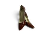 a pair of brown shoes sitting on top of a white surface