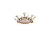 a close up of a crown brooch with pearls on a white background
