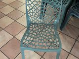 a blue chair that is sitting on a tile floor