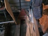 a pile of junk in a garage next to a pile of wood