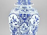a blue and white vase with a lid on a table