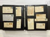 an old black folder with a lot of old letters on it