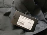 a label on the back of a jacket with a tag on it