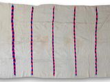 a white rug with red and blue stripes on it